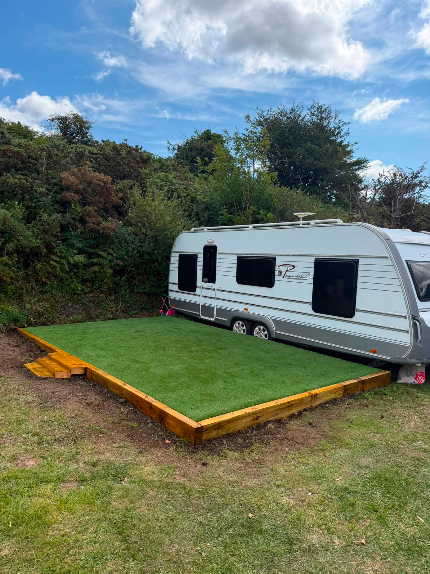 Level artificial grass base for a touring caravan, framed with new timber sleepers — Shrewsbury